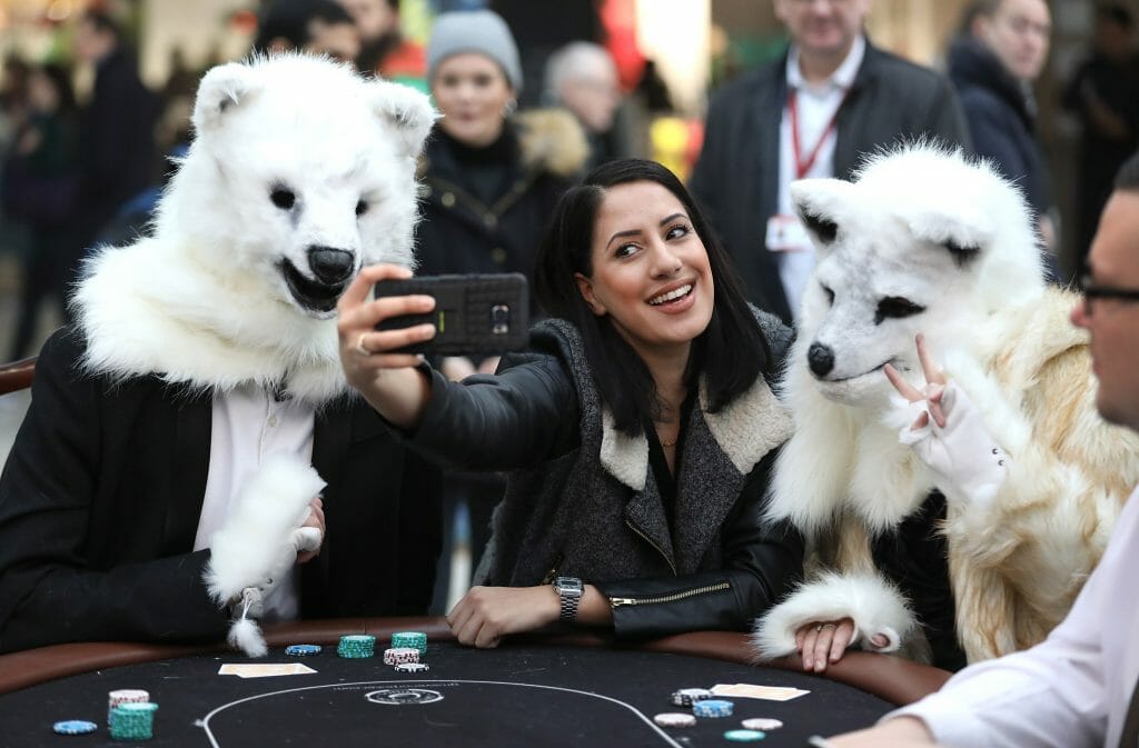 LONDON, ENGLAND - DECEMBER 07: A commuter takes a selfie as Grosvenor Casinos launches 'Call Of The Wild' Christmas campaign with an inspired re-creation of an iconic image at Waterloo Station on December 7, 2016 in London, England. For more information please contact grosvenor@publicasity.co.uk (Photo by Tim P. Whitby/Getty Images for Grosvenor Casinos)